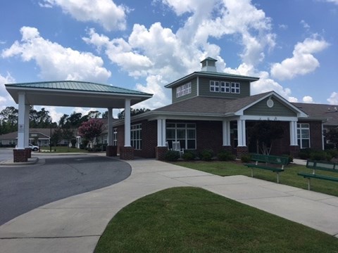 A building with a green roof and a covered walkway.