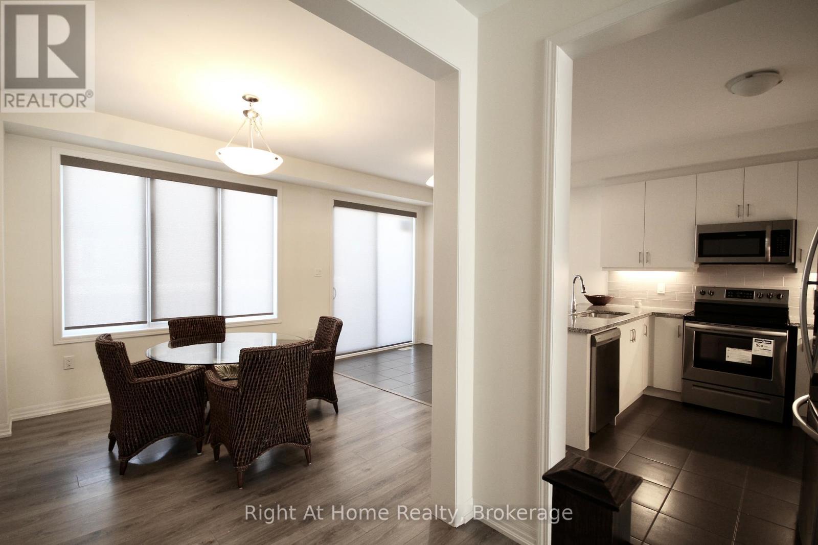 A modern kitchen with a dining table and chairs.