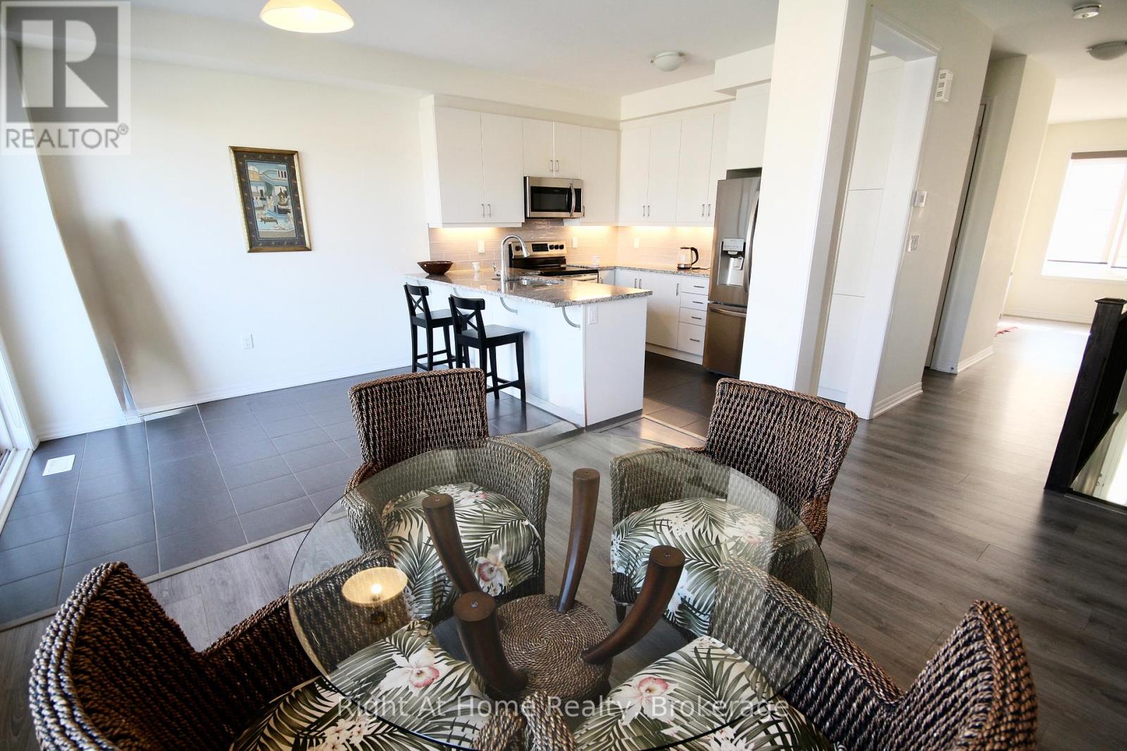 A modern dining room with a glass table and chairs.