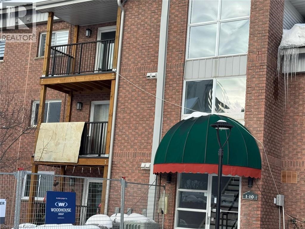 A building with a green awning and a sign that says "Woodhouse".