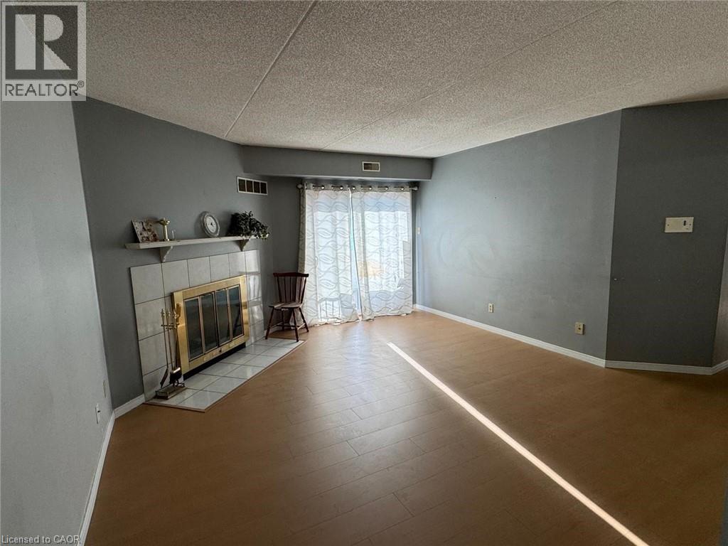 A living room with a fireplace and a sliding glass door.