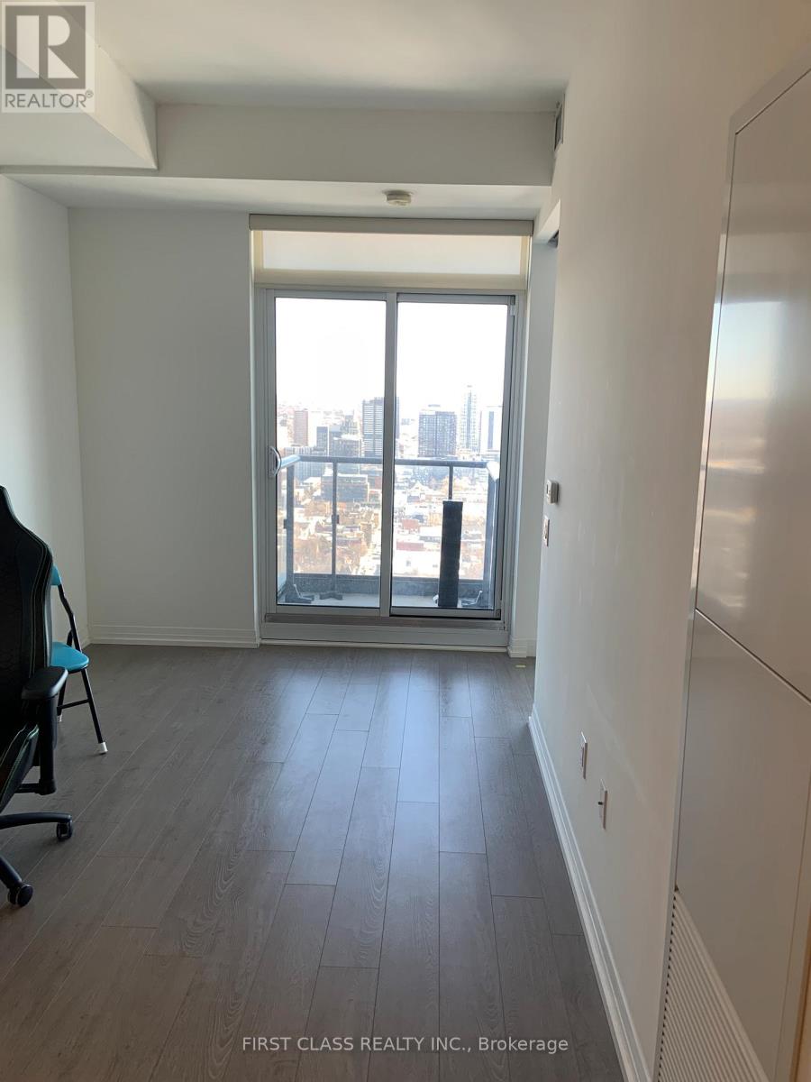 A room with a view of the city through a large window.