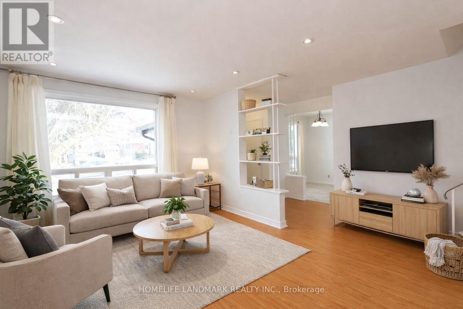 A living room with a couch, a coffee table, and a television.