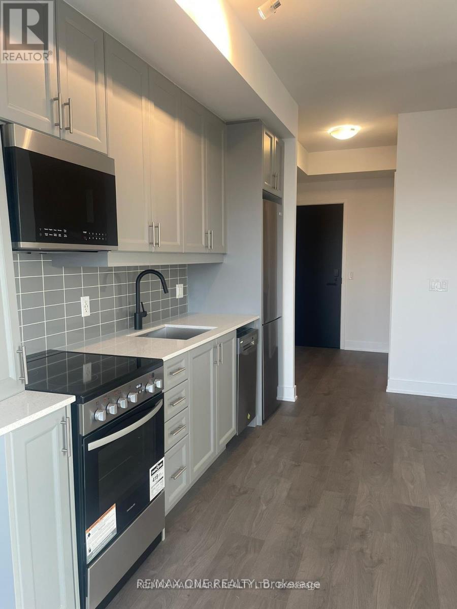 A kitchen with white cabinets and a black stove top.