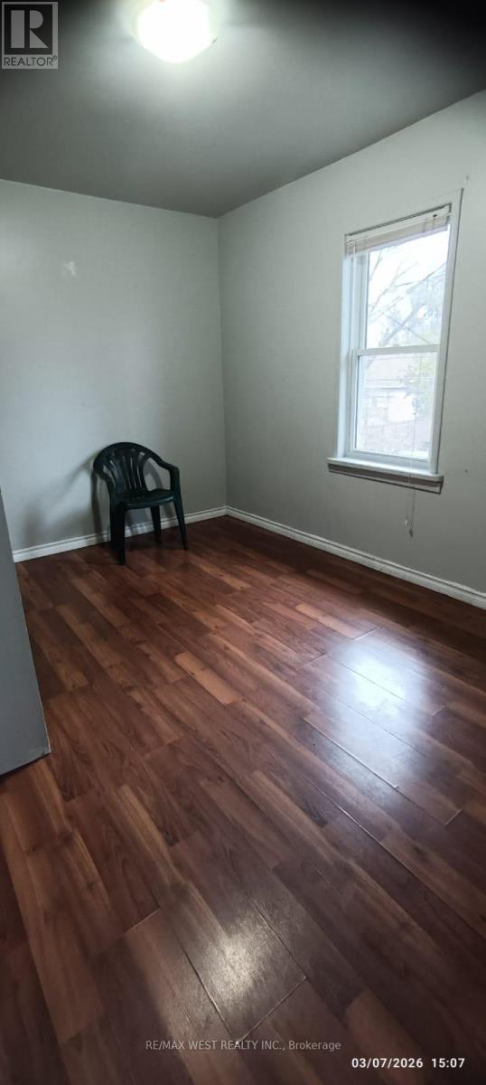 A room with a wooden floor and a window.