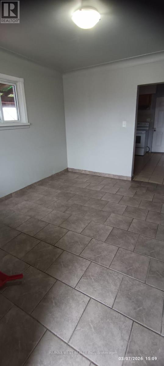 A room with a tile floor and a window.