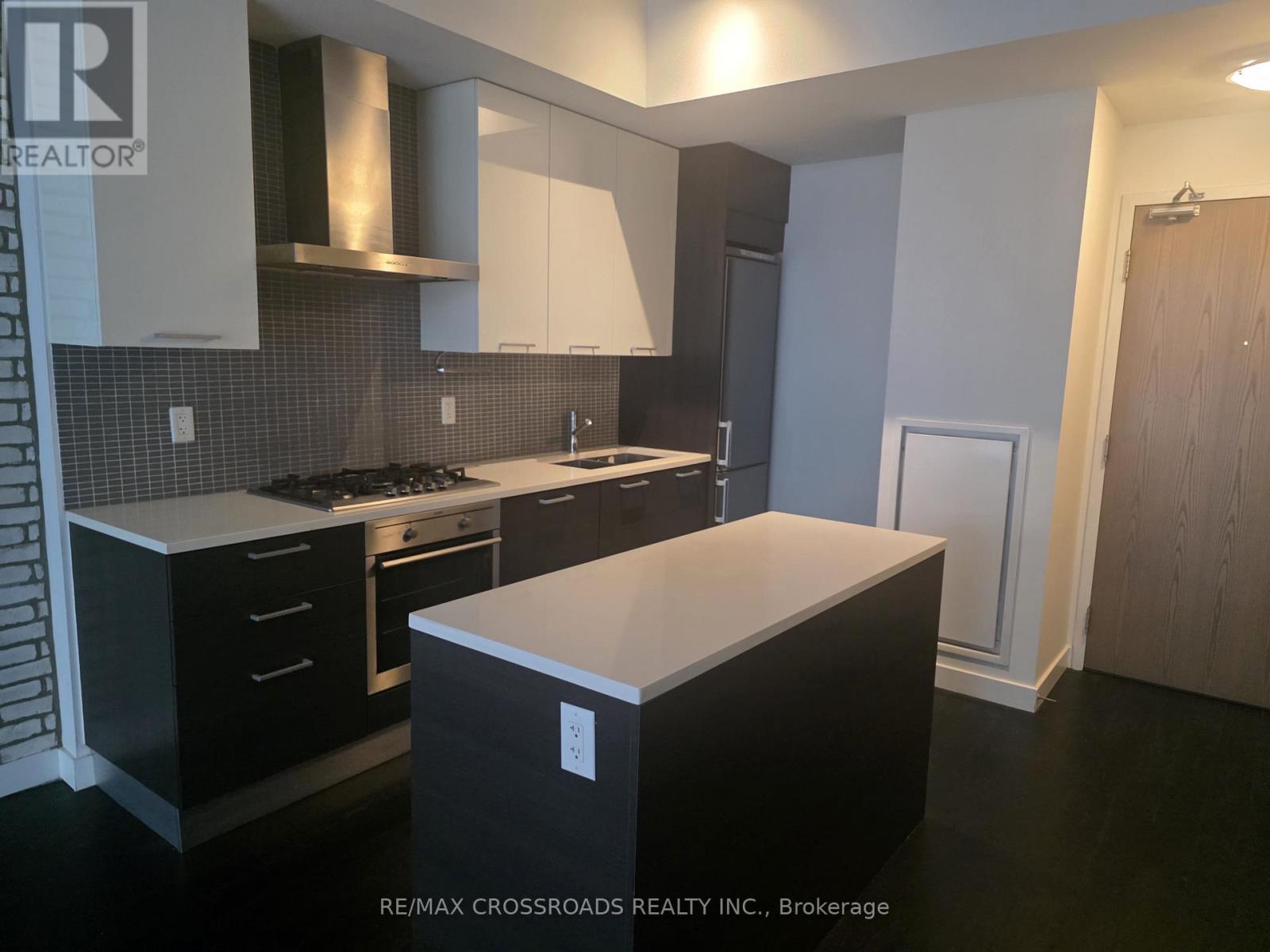 A kitchen with a black countertop and stove.