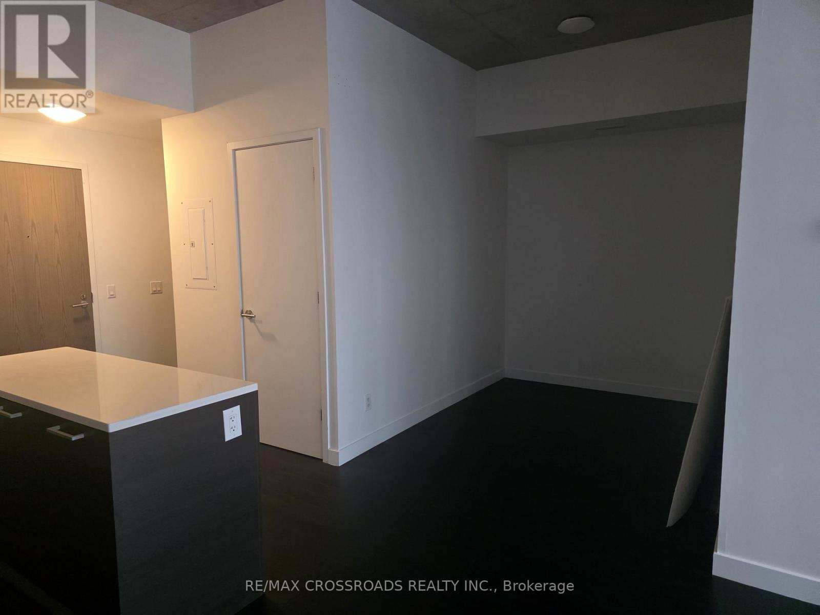 A room with a desk and a cupboard in it.