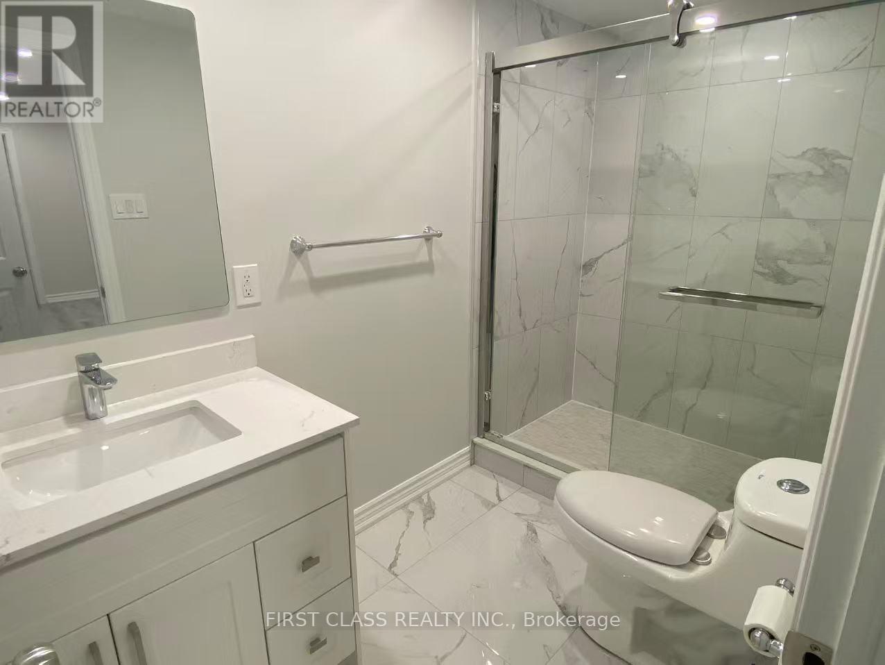 A bathroom with a sink, toilet, and shower.