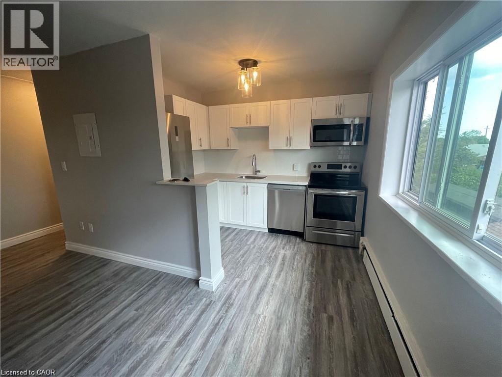 A kitchen with a stove top oven and microwave.