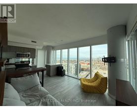 A living room with a large window overlooking a cityscape.
