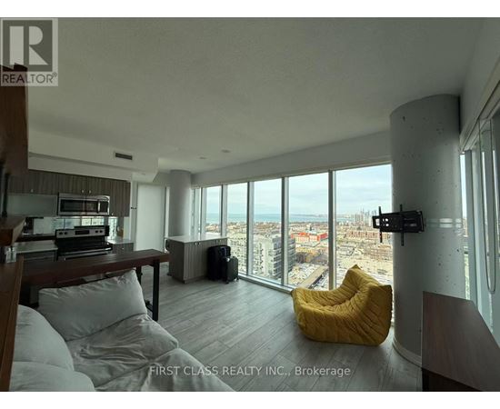 A living room with a large window overlooking a cityscape.