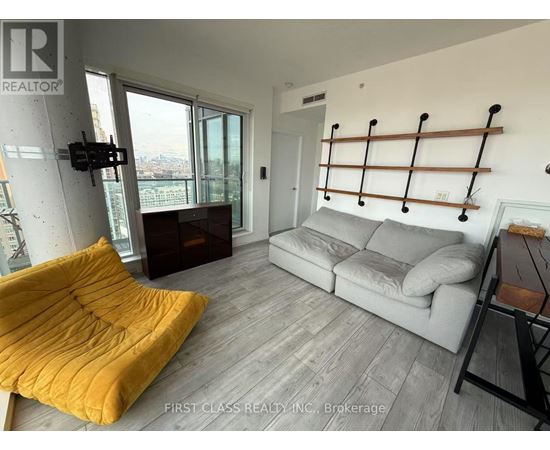A living room with a grey couch and a yellow chair.