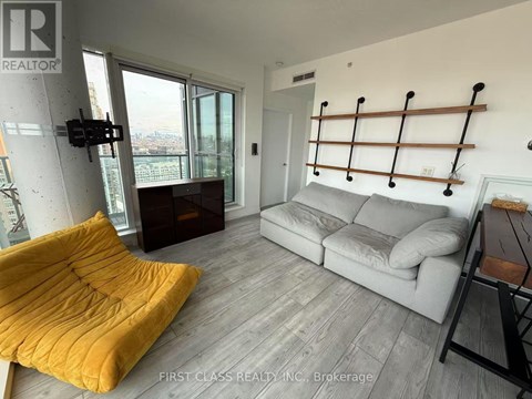 A living room with a grey couch and a yellow chair.