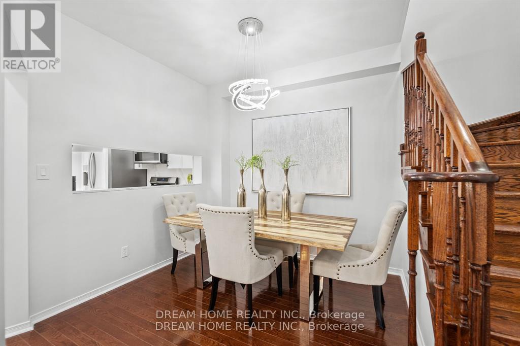 A dining room with a wooden table and chairs.