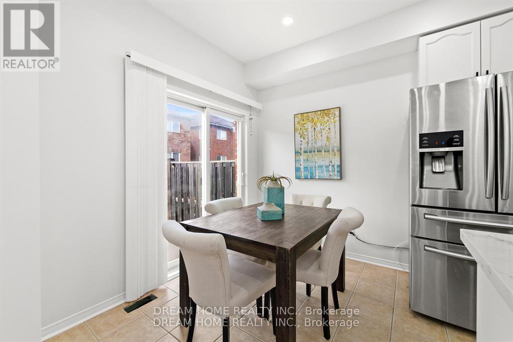 A modern kitchen with a dining table and chairs.