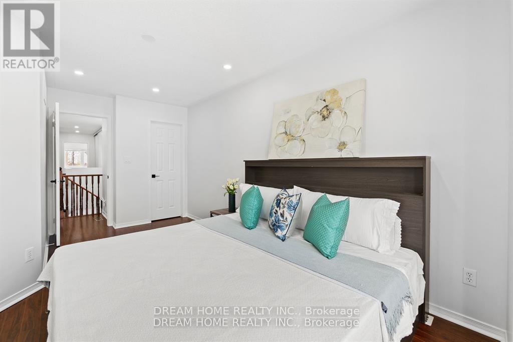 A bedroom with a large bed and a painting on the wall.