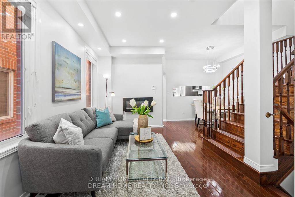 A modern living room with a grey sofa and a glass coffee table.
