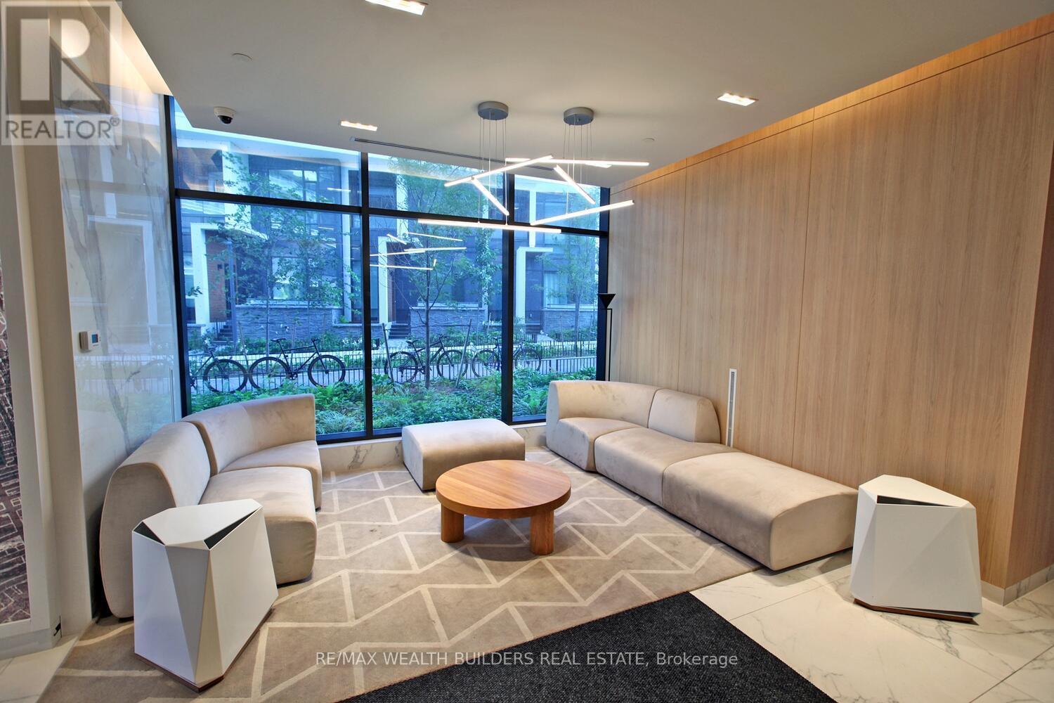 A modern waiting room with a view of the outside courtyard.