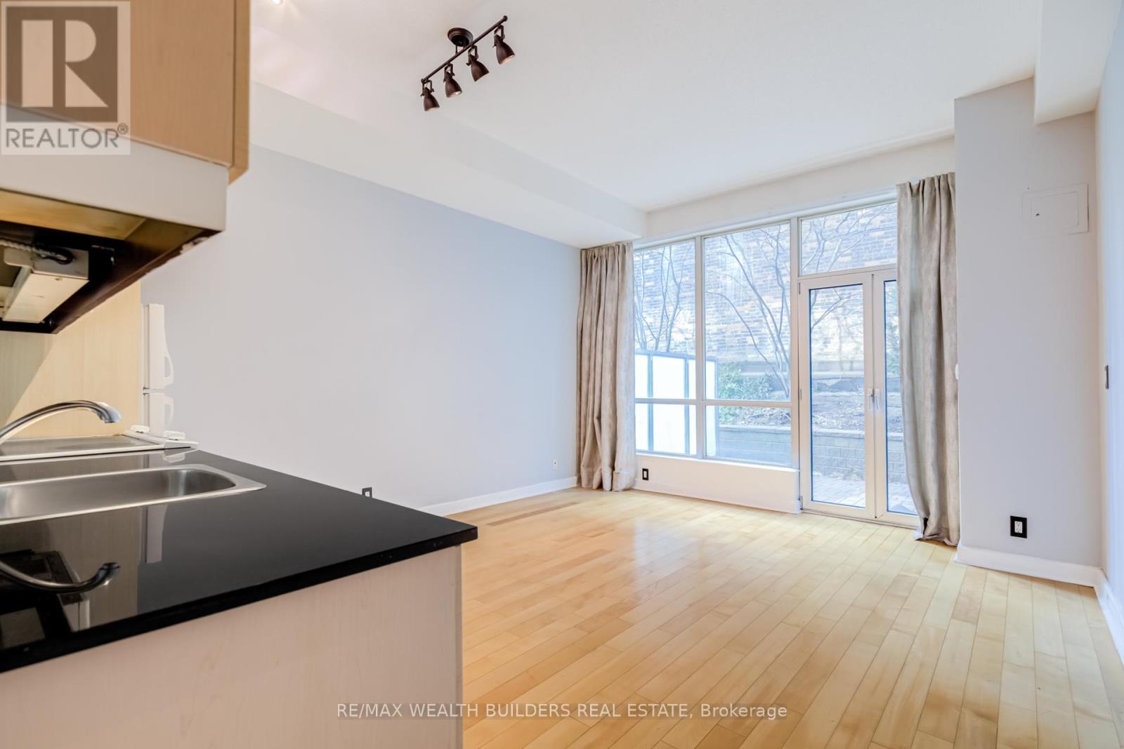 A kitchen with a sink and a counter top.