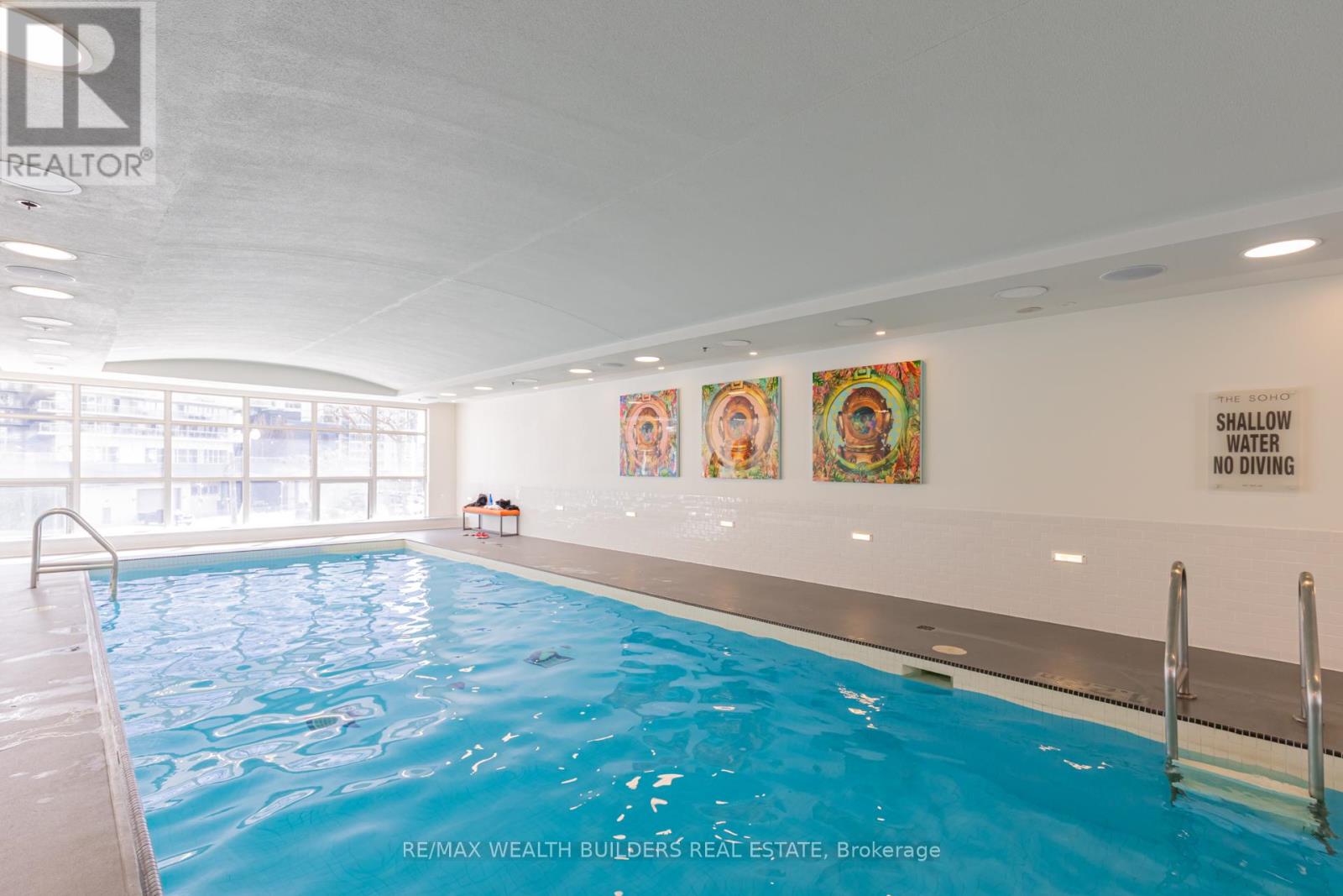 A pool with a sign that says shallow water no diving.