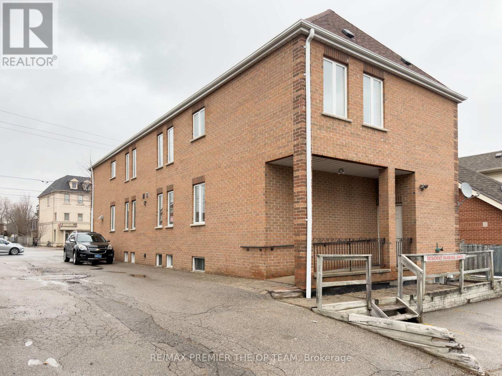 A brick building with a car parked in front.