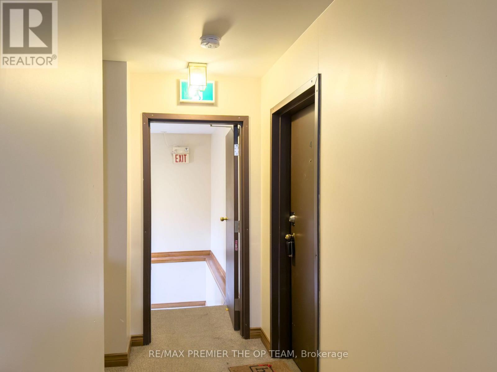 A hallway with a door on the right and another door on the left.