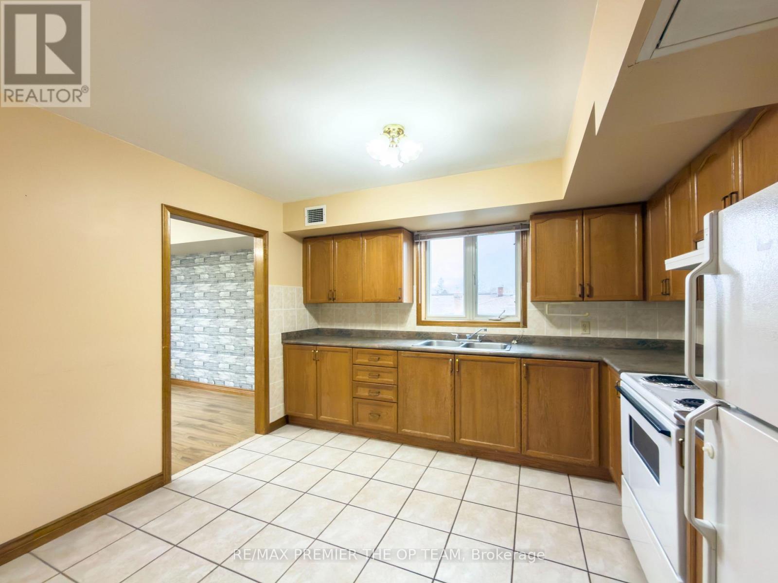A kitchen with wooden cabinets and a white refrigerator.
