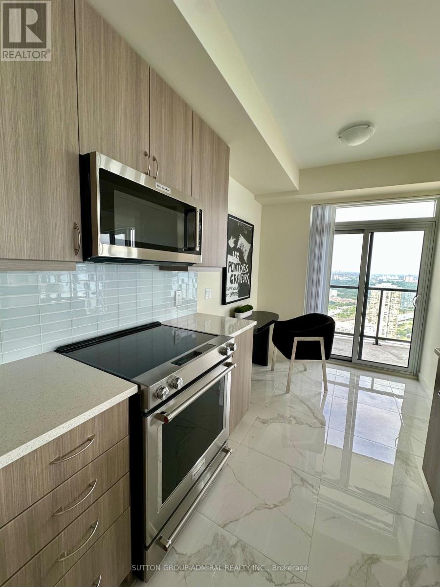 A kitchen with a black stove top oven and a black microwave above it.