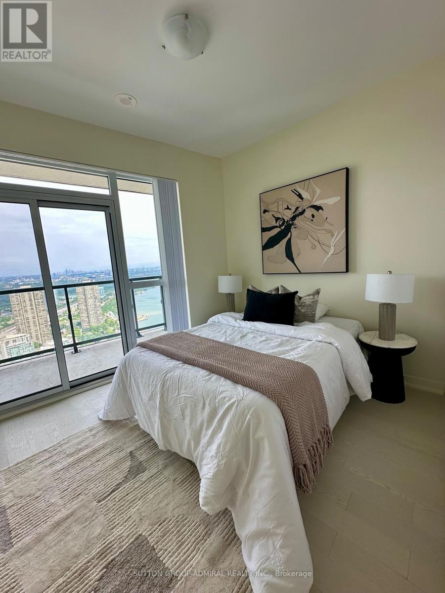 A bedroom with a large bed and a view of the city.