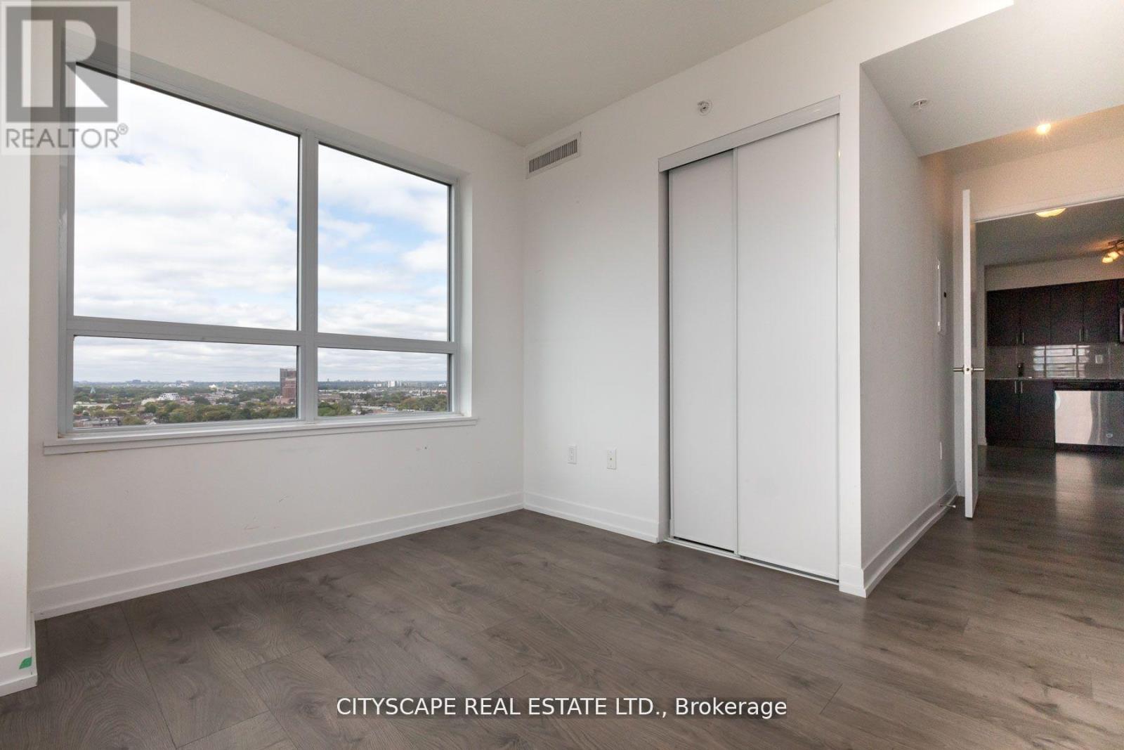 A room with a large window and a sliding door.