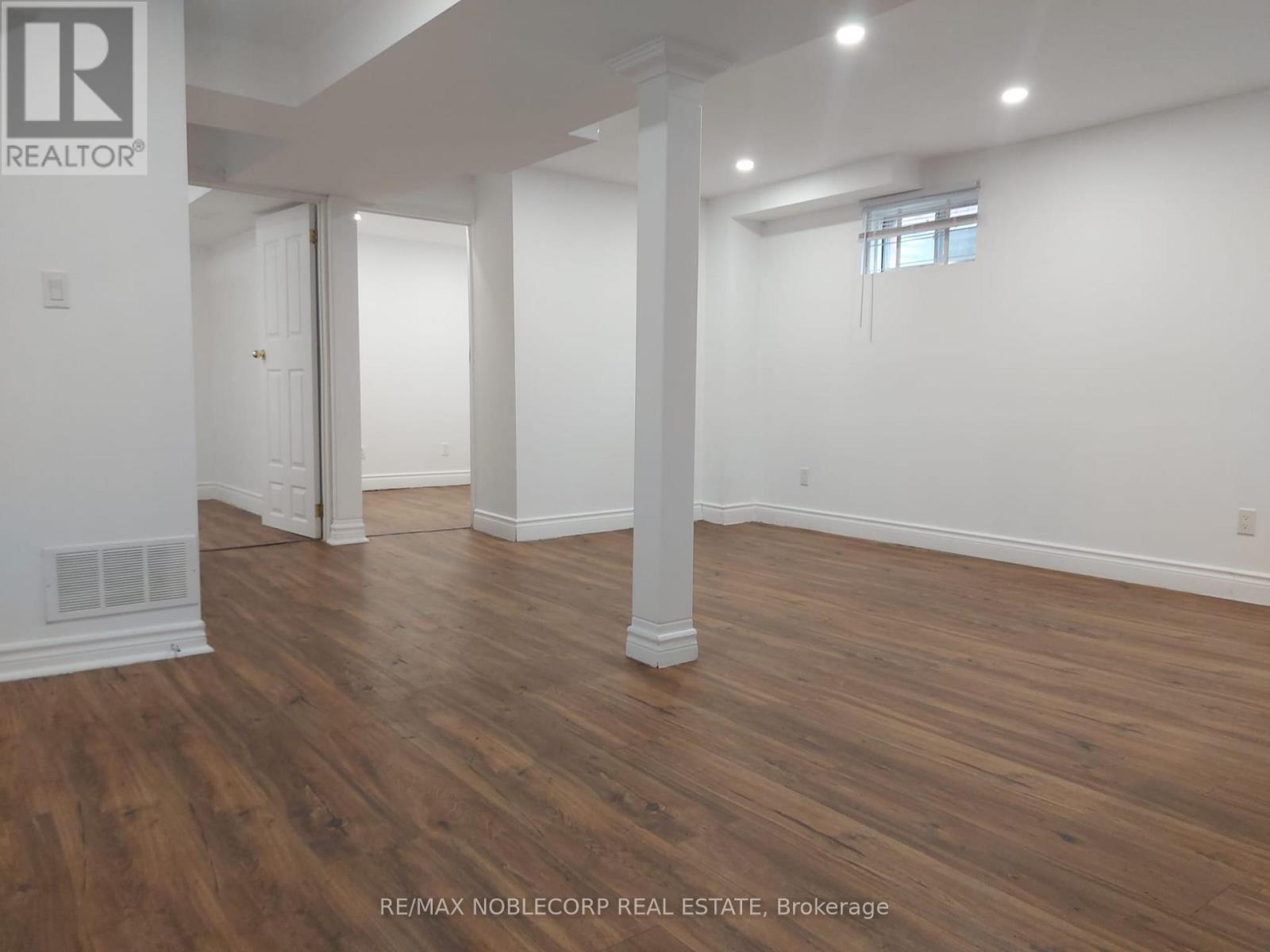 A room with wooden floors and white walls.