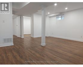 A room with wooden floors and white walls.