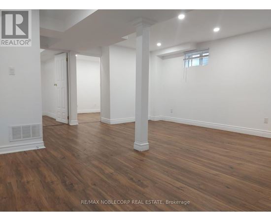 A room with wooden floors and white walls.
