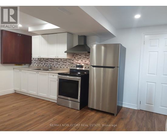 A kitchen with a stainless steel refrigerator and oven.