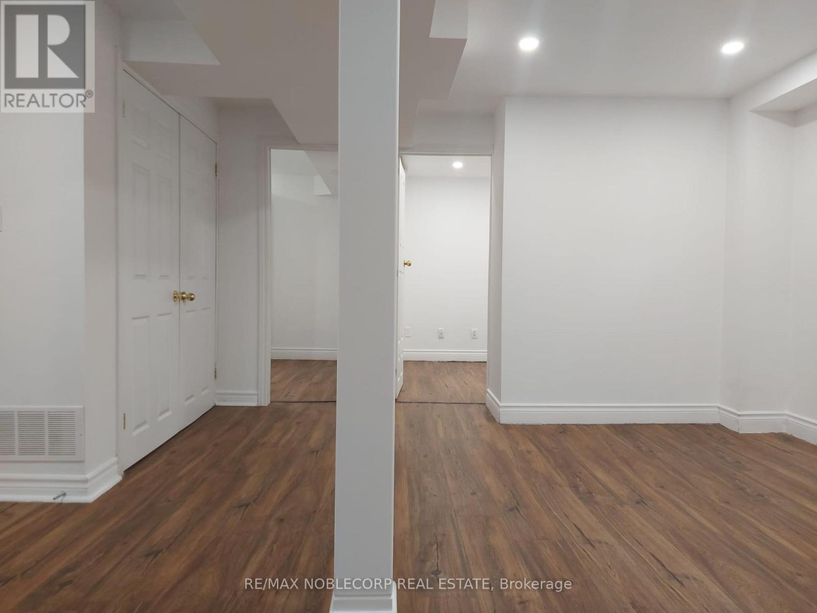 A room with wooden floors and white walls.