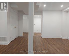 A room with wooden floors and white walls.