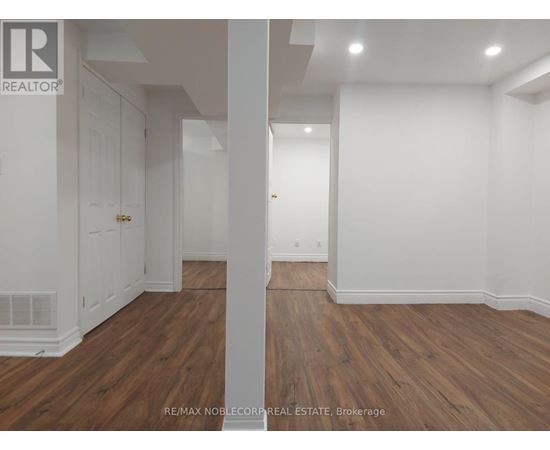 A room with wooden floors and white walls.