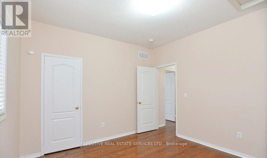 A room with two doors and a window with blinds.