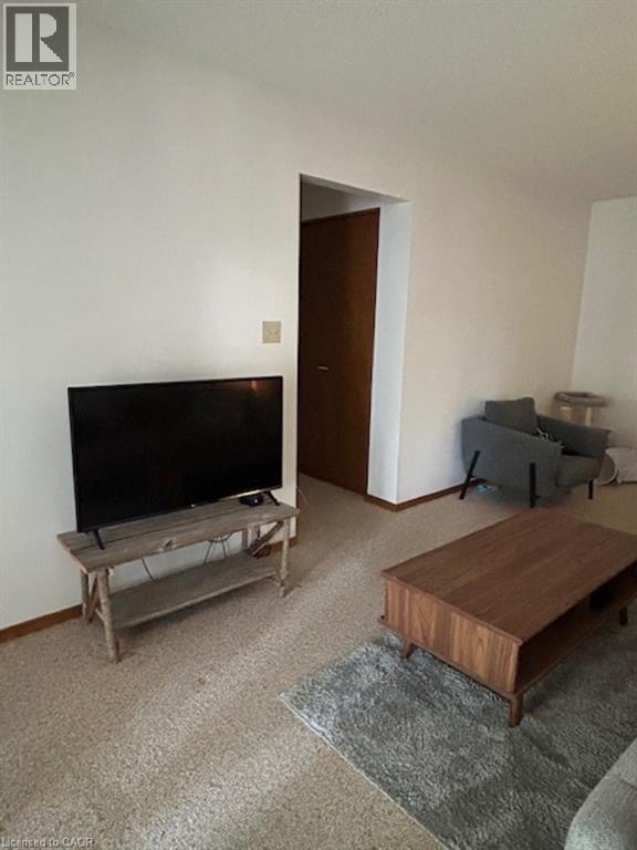 A living room with a television and a couch.