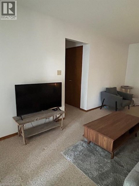 A living room with a television and a couch.