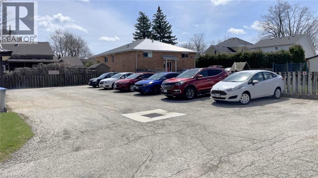 A parking lot with cars and a building in the background.