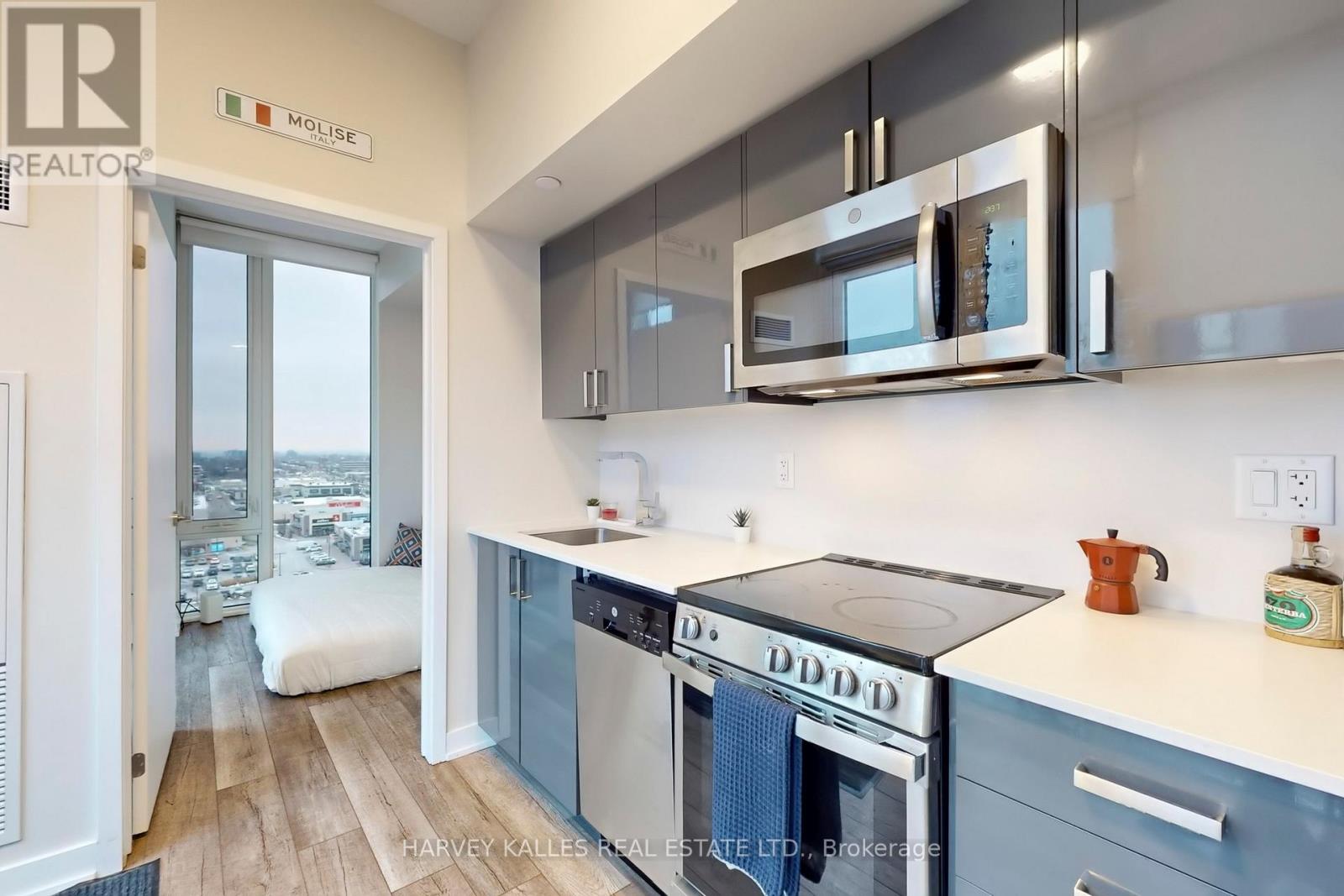 A kitchen with a stove top oven and a microwave above it.