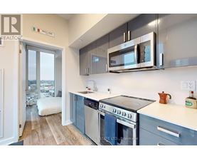 A kitchen with a stove top oven and a microwave above it.