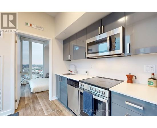 A kitchen with a stove top oven and a microwave above it.