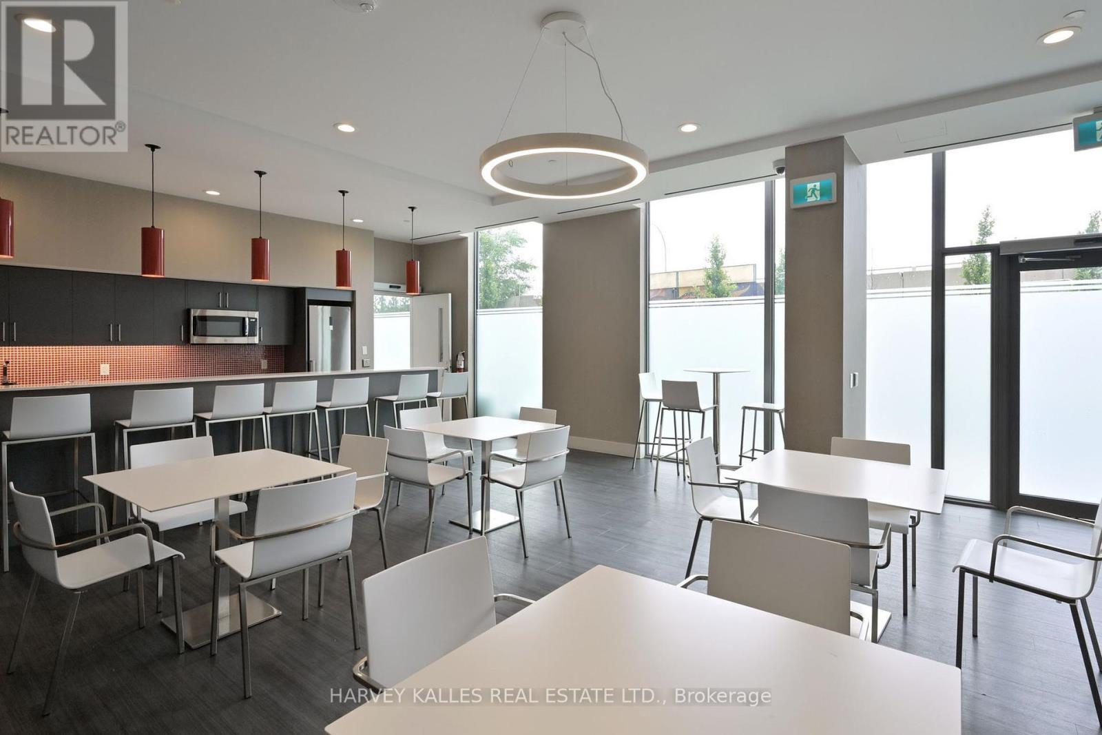A modern dining area with white tables and chairs.