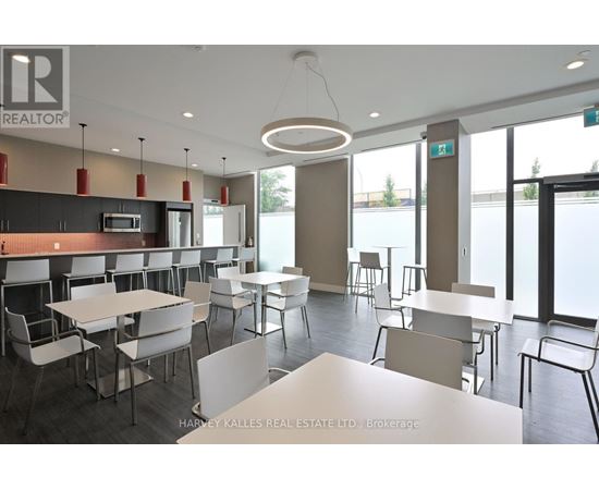 A modern dining area with white tables and chairs.