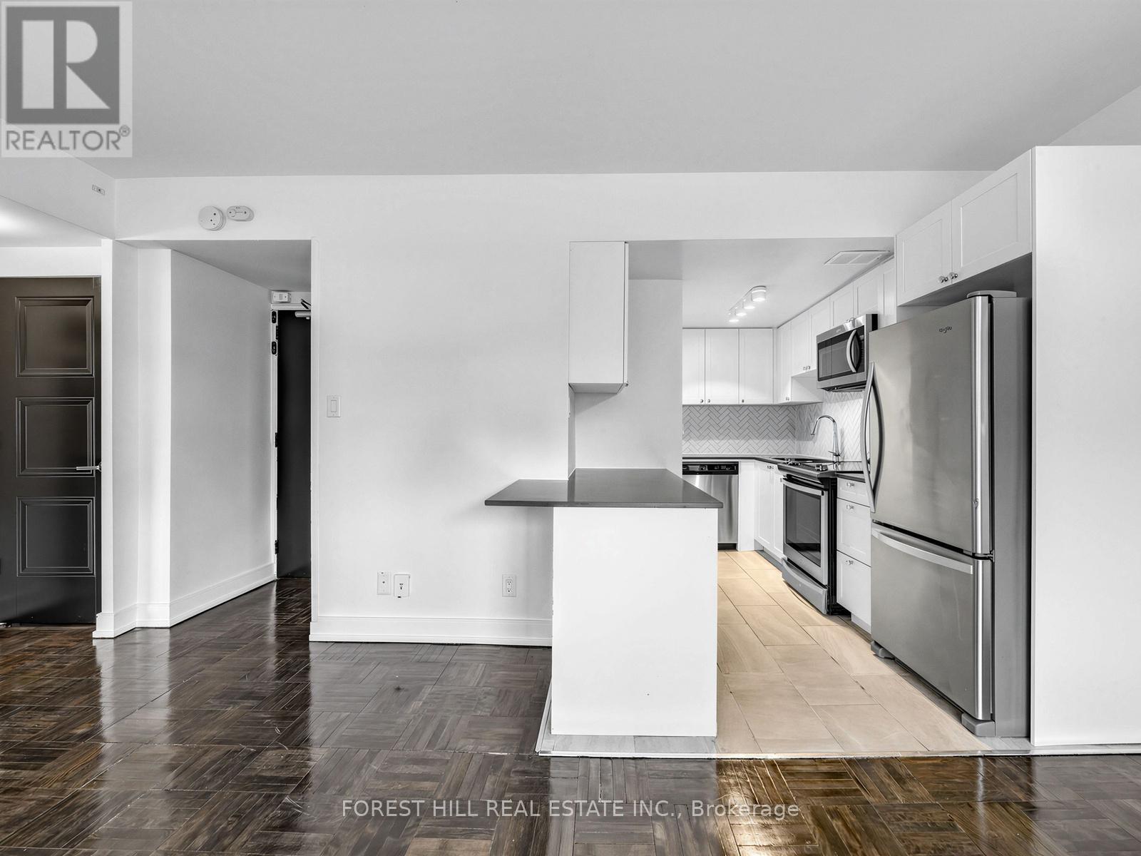 A kitchen with a white fridge and stove top oven.