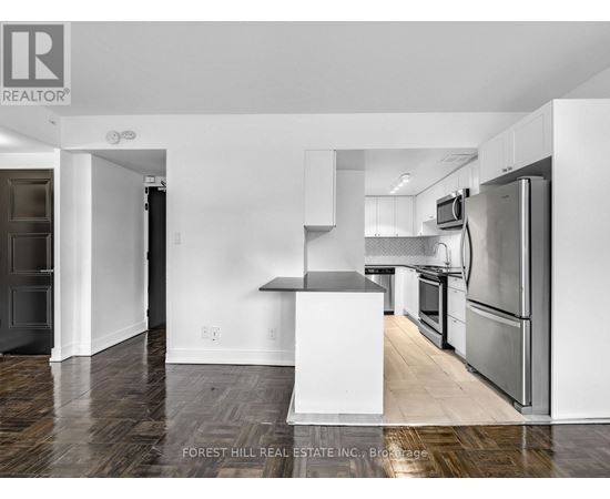 A kitchen with a white fridge and stove top oven.