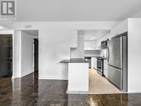 A kitchen with a white fridge and stove top oven.